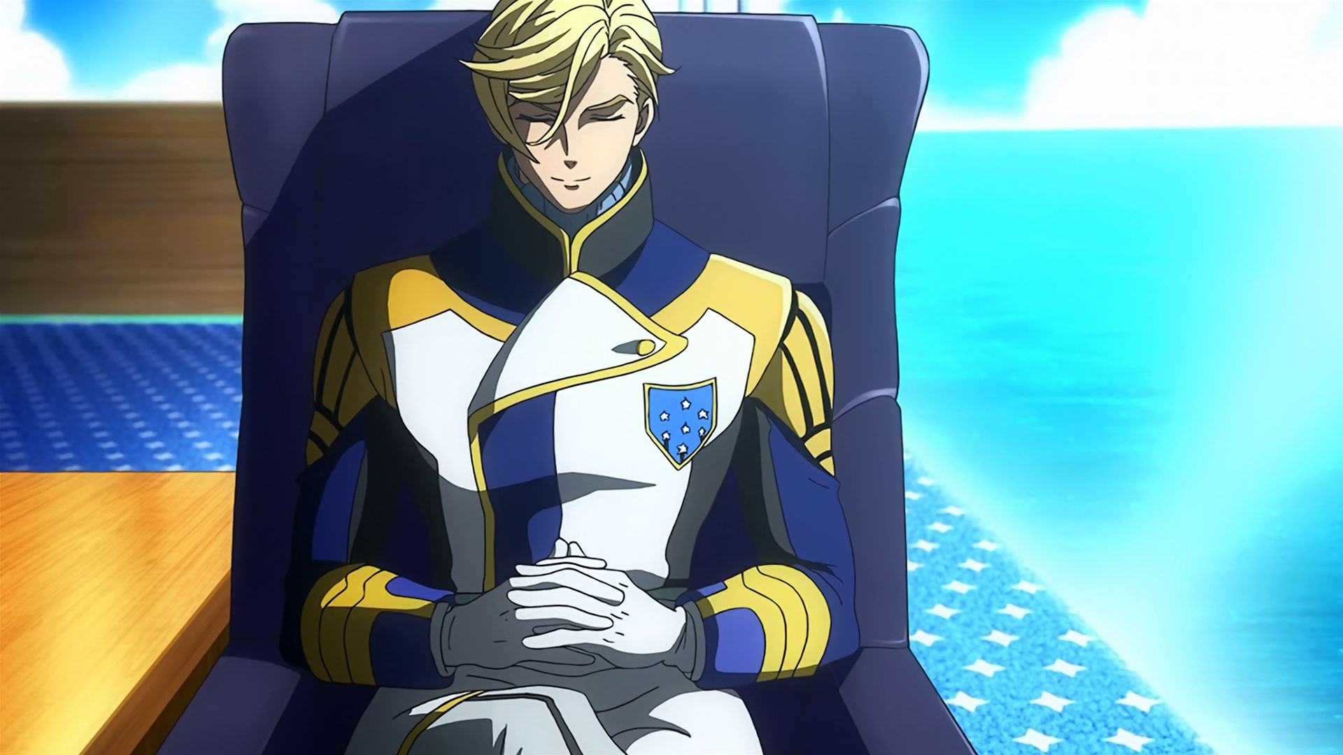 McGillis sitting in a chair with his eyes closed and smiling.