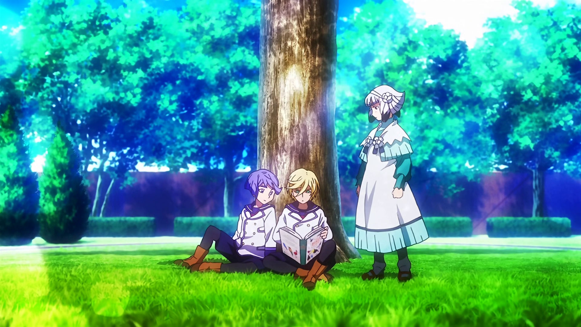 Young Gaelio, McGillis and Carta, they're all looking at a book that McGillis is holding, Carta is standing up while the other two are sitting down next to a tree.