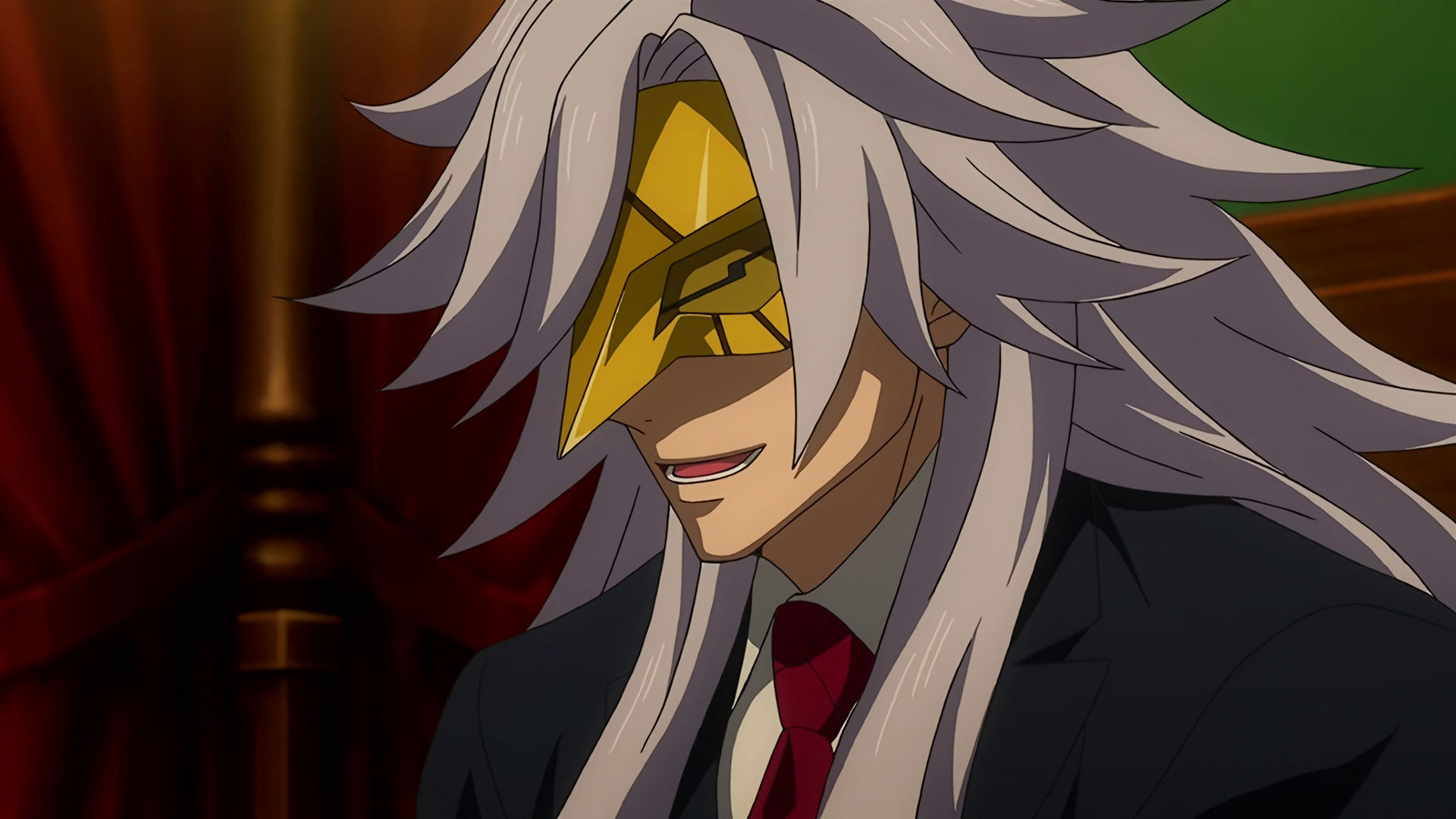 McGillis wearing a golden mask with long gray hair, his eyes are hidden by the mask. 