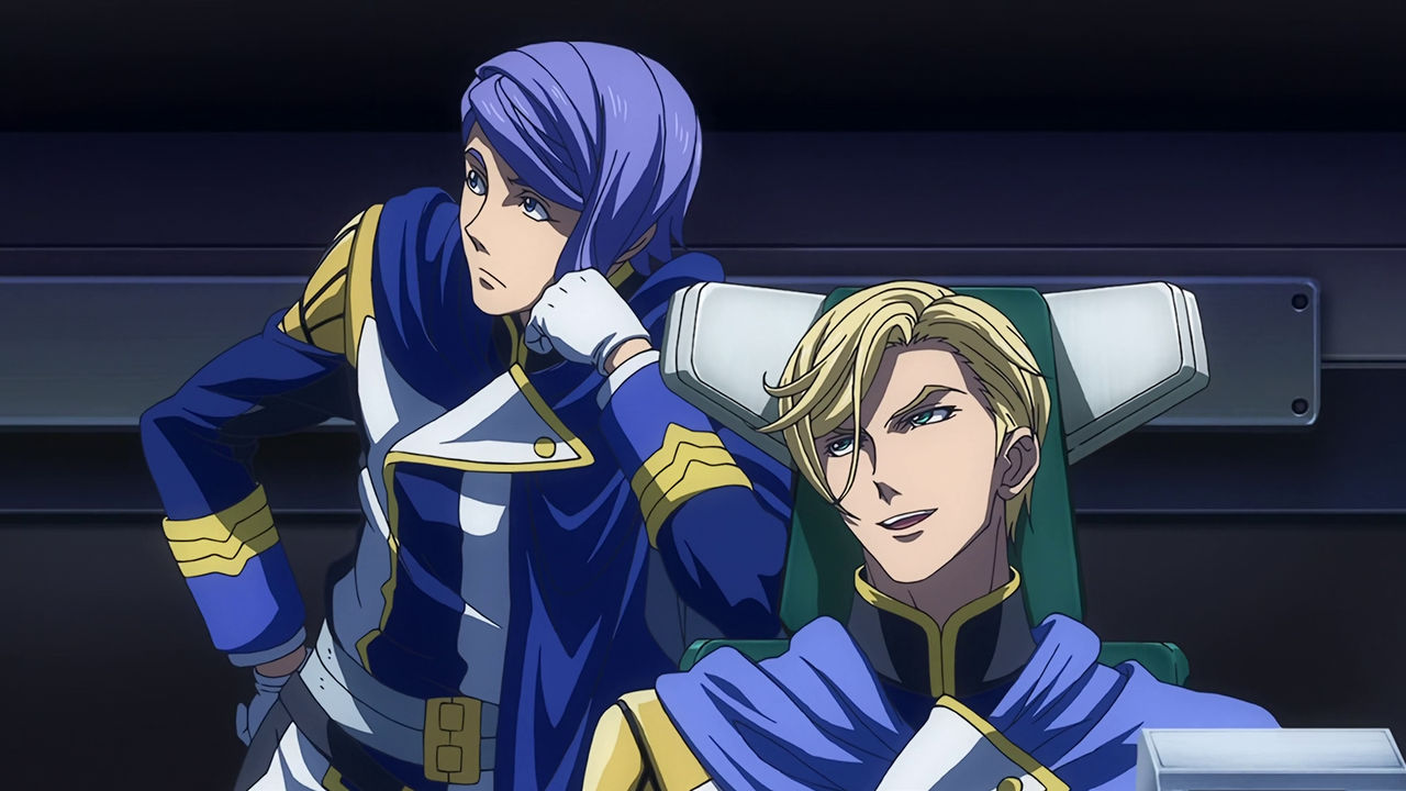 McGillis sitting on a chair looking and playfully talking to Gaelio who is leaning on McGilli's chair looking away uninterested