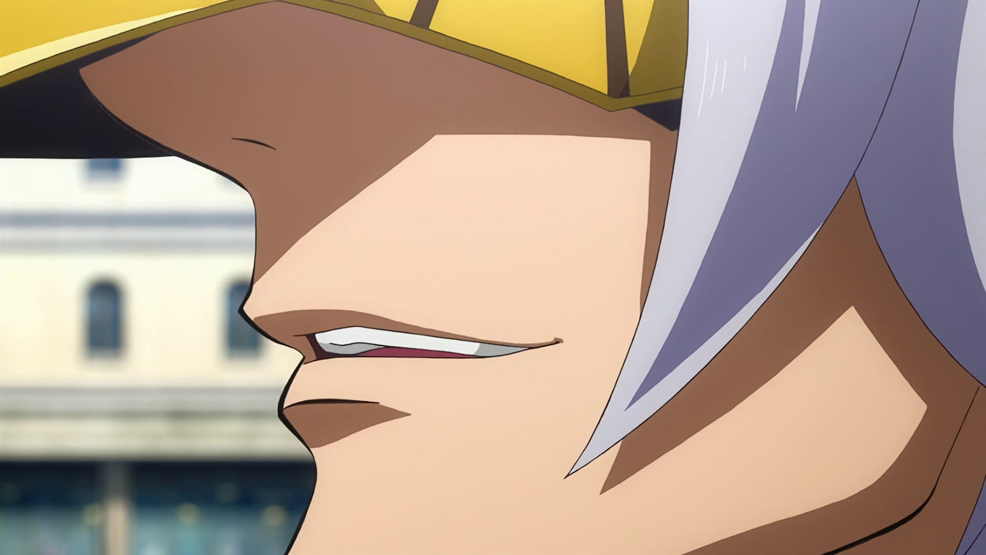 A closeup of McGillis mouth while he is wearing a golden mask with long gray hair.