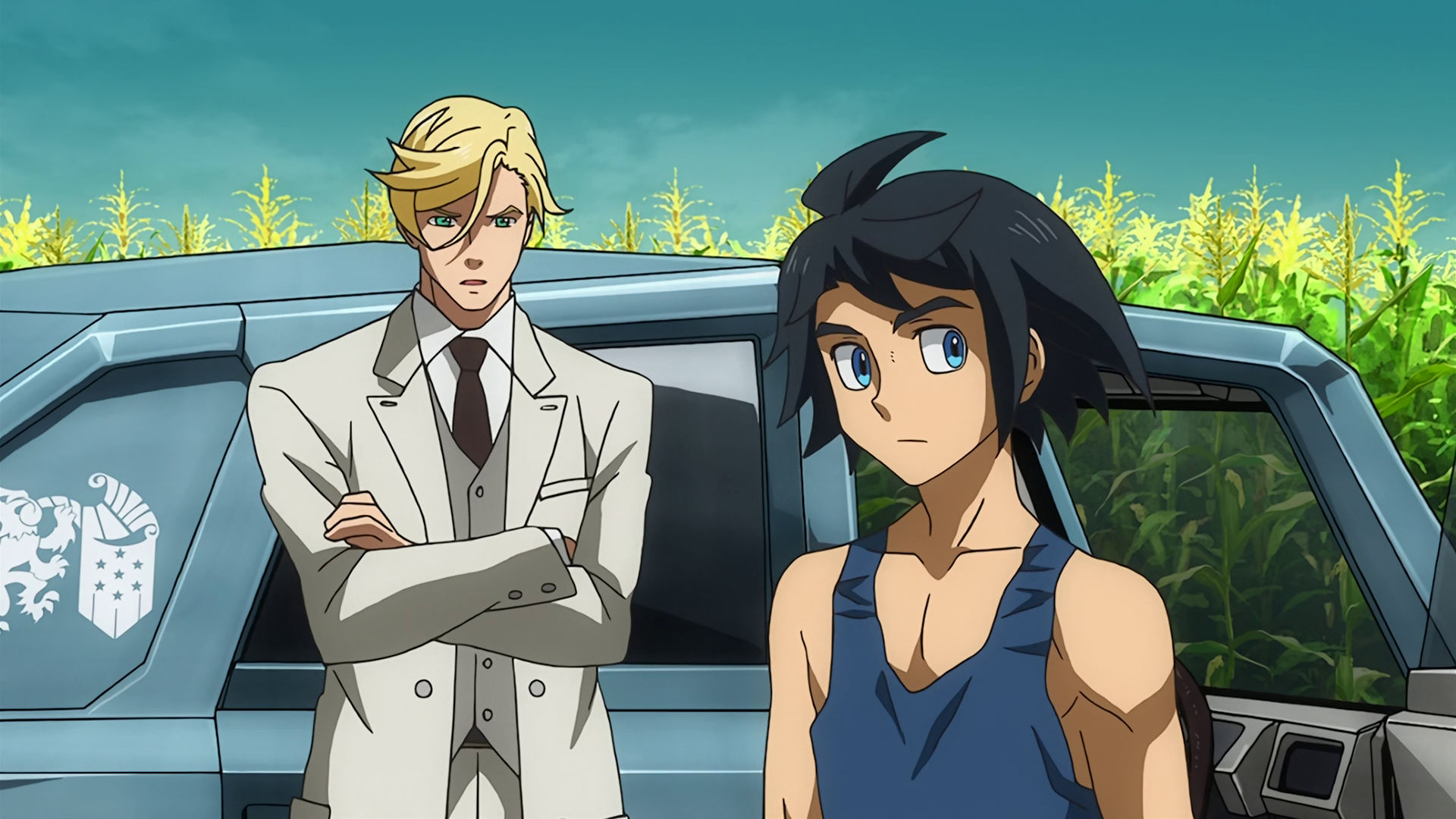 McGillis and Mikazuki standing in front of a cyan Gjallarhorn car and a cornfield