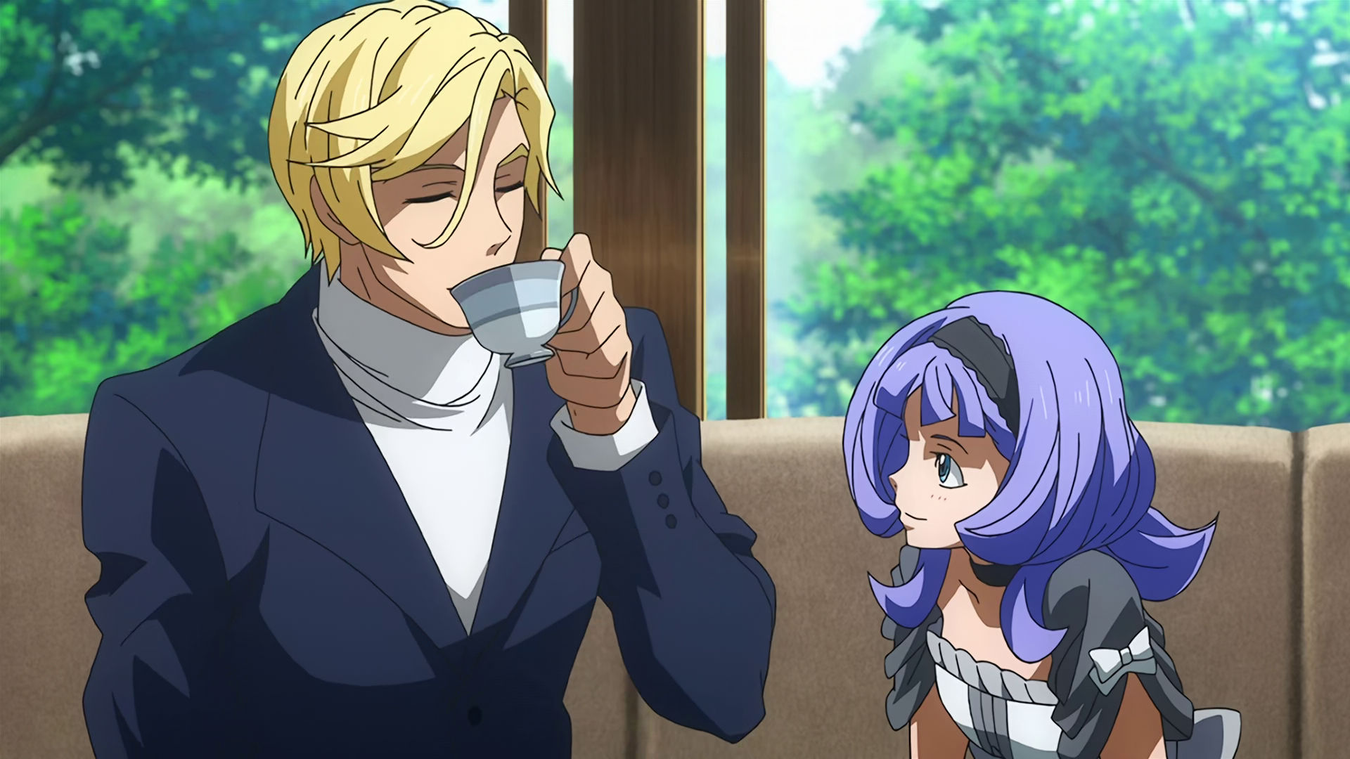 McGillis wearing a black suit and white turtleneck happily drinking tea next to Almiria.