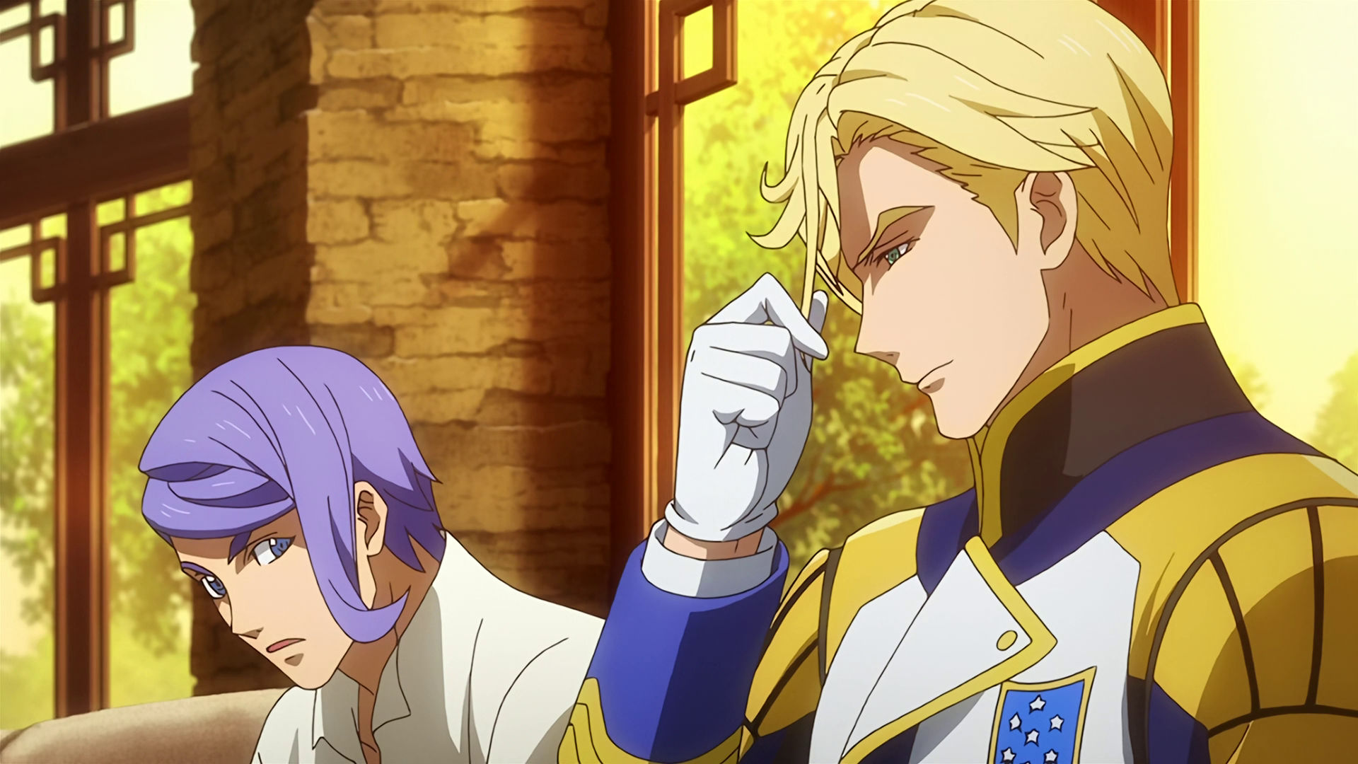 McGillis sitting down he looks serious and is playing with his hair, Gaelio is sitting beside him