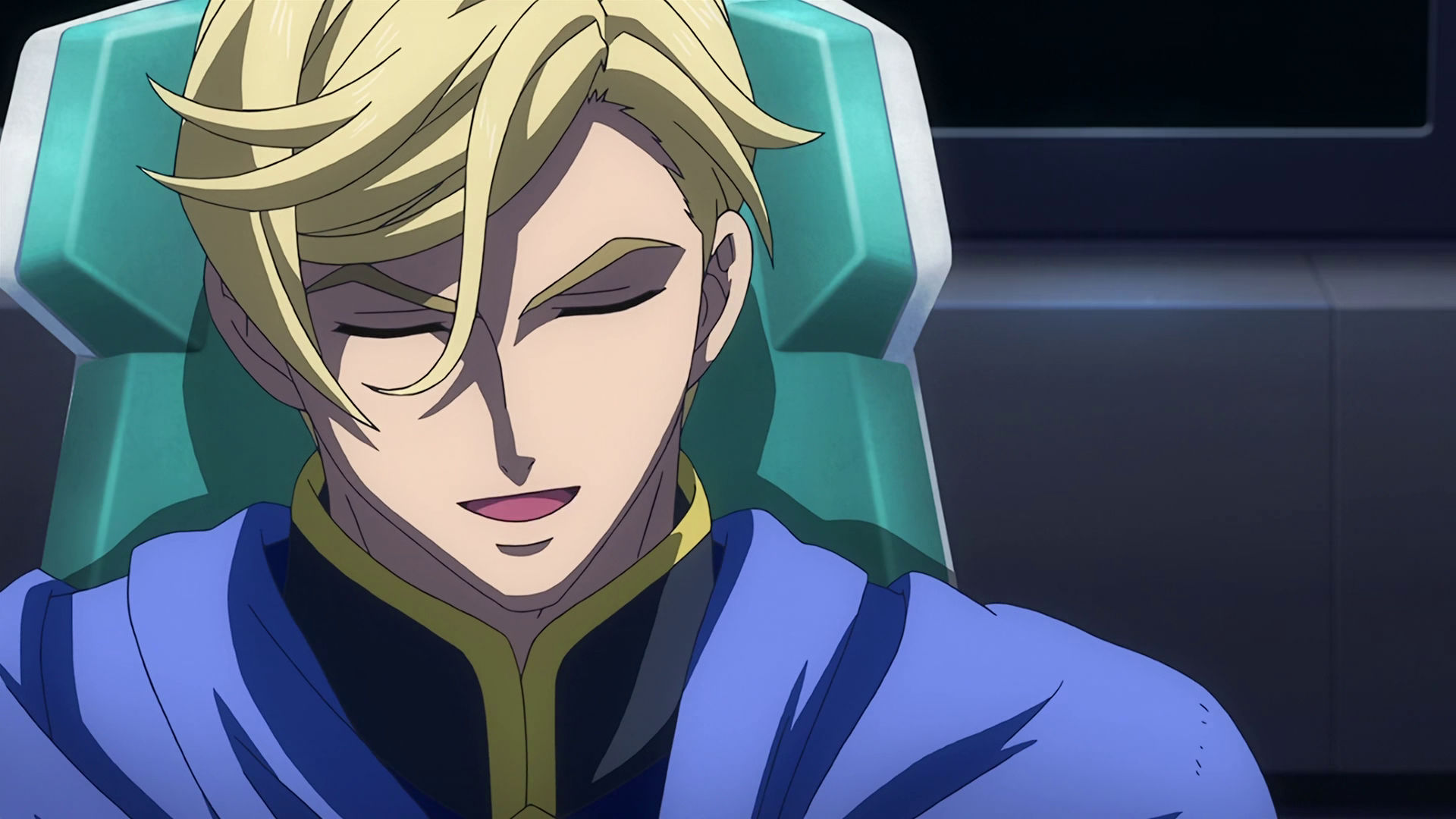 McGillis sitting on a chair laughing with his eyes closed