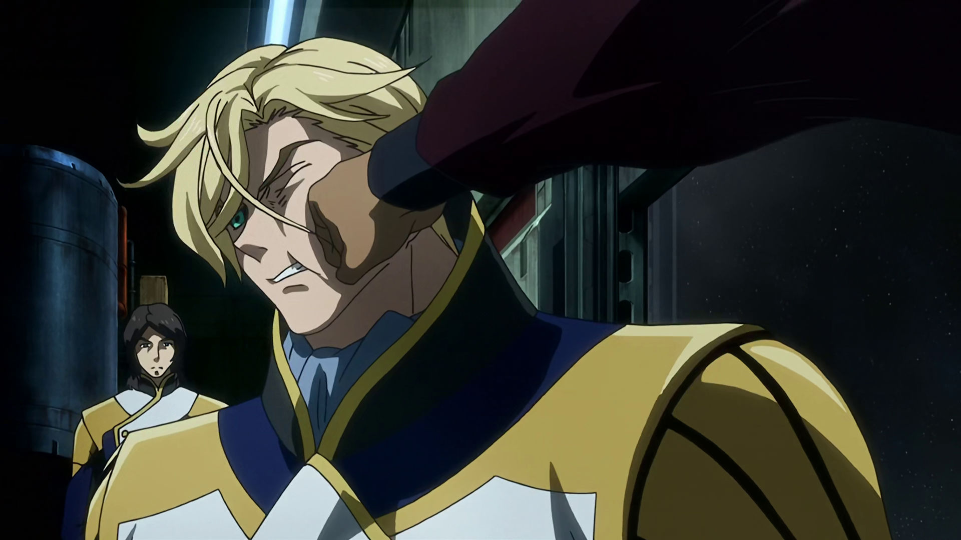 McGillis getting punched in the face by Orga while Isurugi is standing behind him