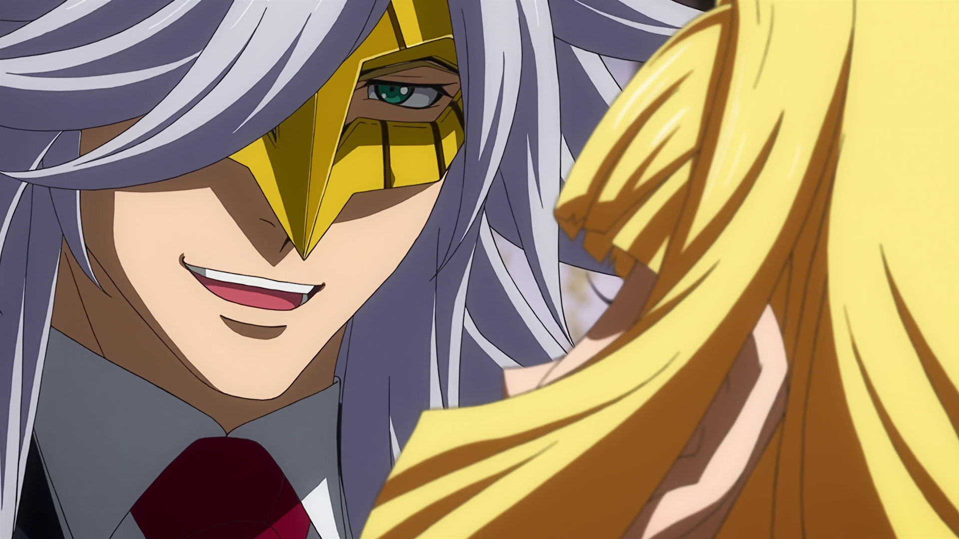 McGillis wearing the golden mask with long gray hair, he is laughing and really close to Kudelia 