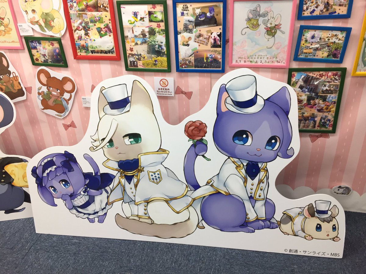 A photo of a cardboard standee of cat Almiria, McGillis, Gaelio and hamster Ein.

McGillis, Gaelio and Ein are wearing fancy white suits with top-hats.