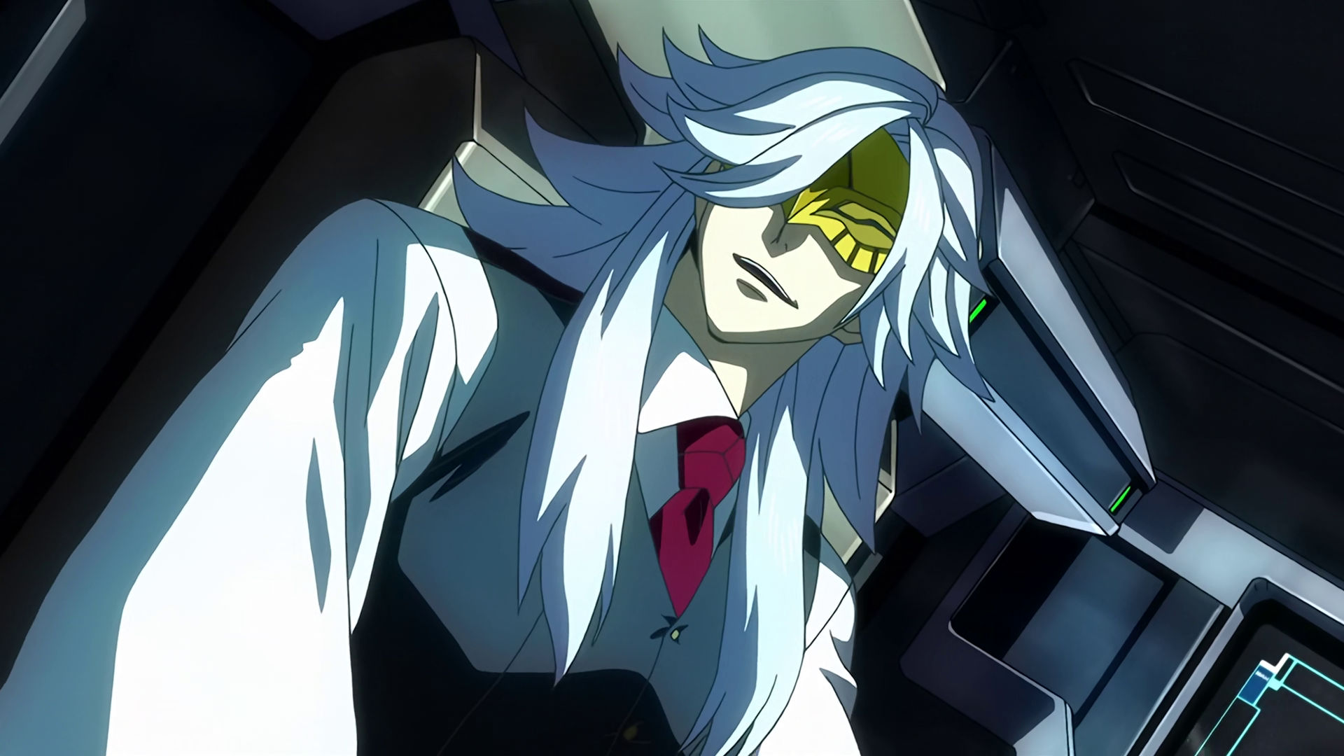 McGillis as Montag inside a mobile suit cockpit, he is smiling while looking to his right.
