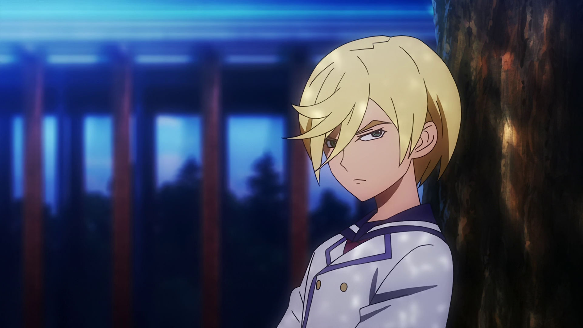 A young McGillis sitting next to a tree, he looks annoyed.