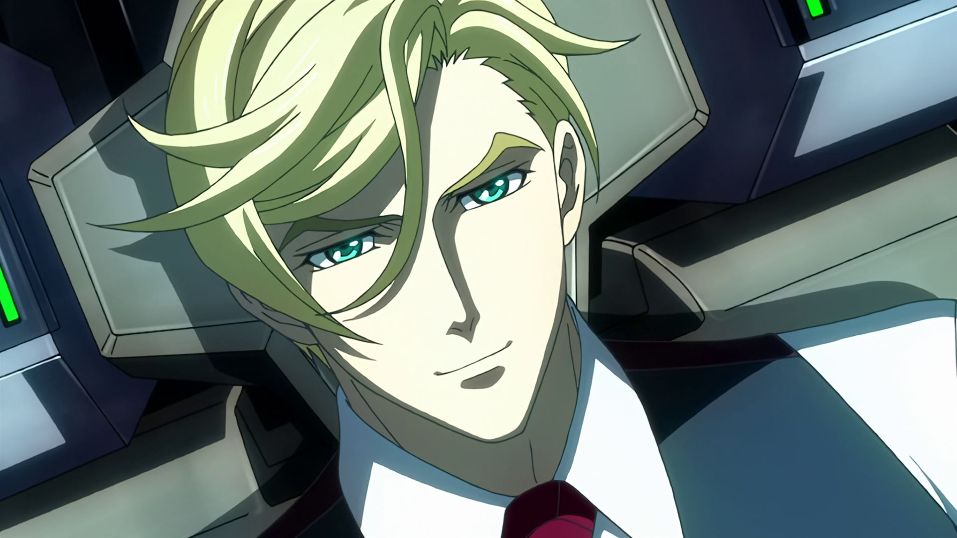 McGillis inside a mobile suit cockpit, he is smiling.