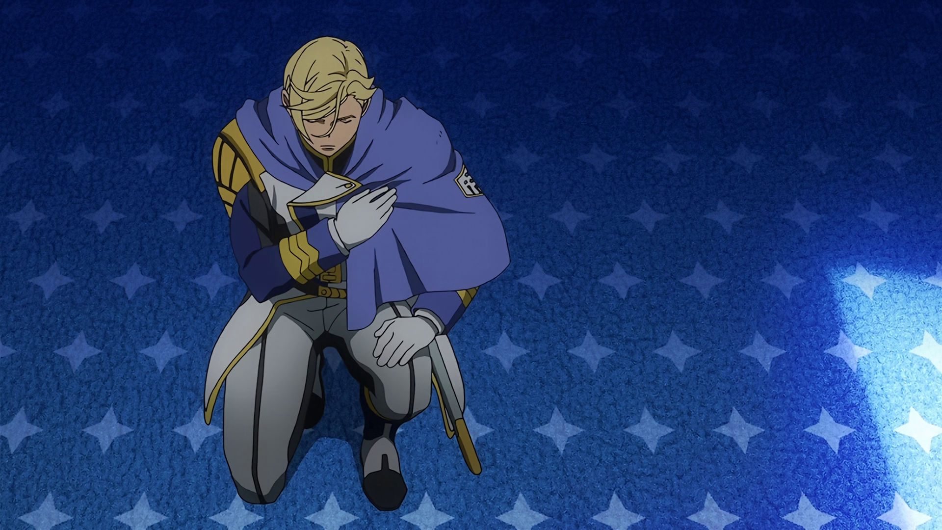 McGilling bowing down with one hand on his chest and the other on his knee, he looks sad.