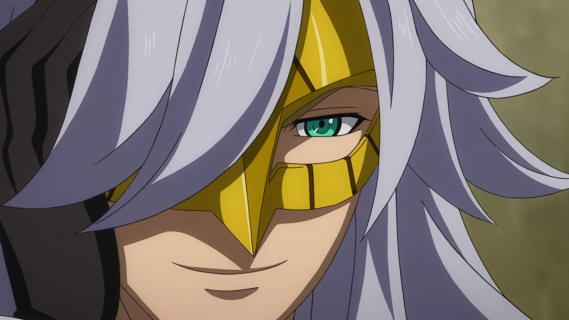 McGillis wearing a golden mask with long gray hair, his eyes are now visible and he is smiling. 